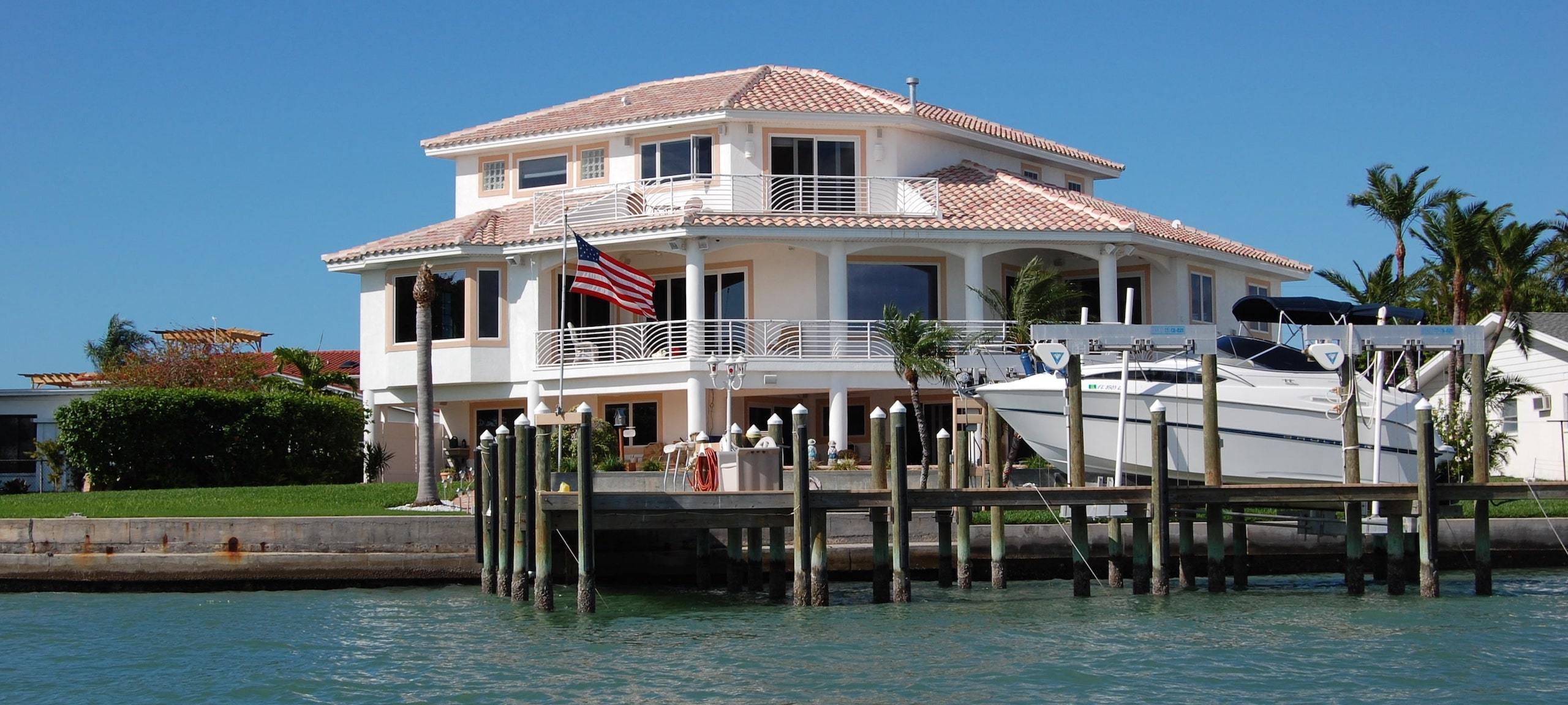 Luxury Florida lakeside home with a boat docked.